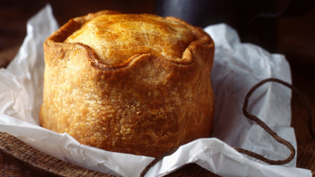 Close up of pork pie on wooden board